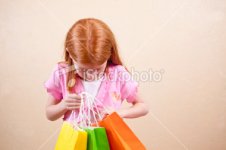 ist2_8865440-red-haired-girl-with-shopping-bags.jpg